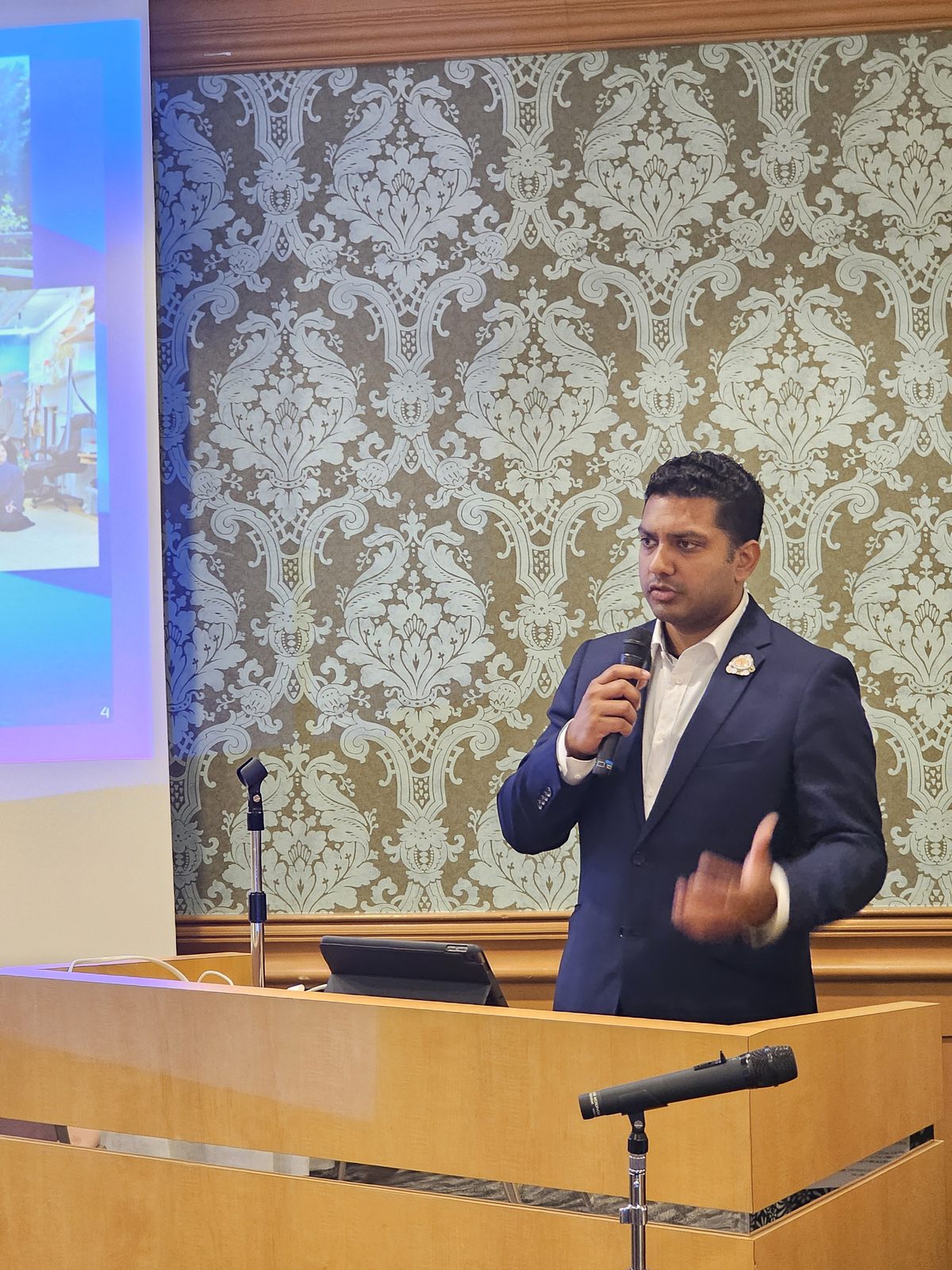 Dr. DhruBee at a podium during a speaking engagement